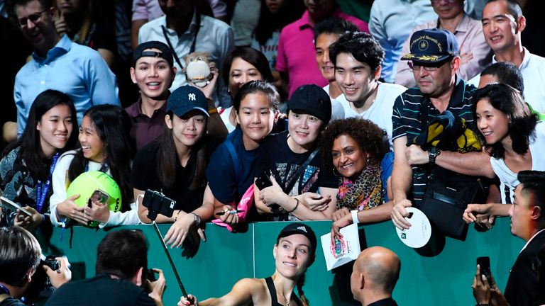 Angelique Kerber schießt nach ihrem Sieg gegen Naomi Osaka beim WTA-Finale in Singapur ein Selfie mit Fans.