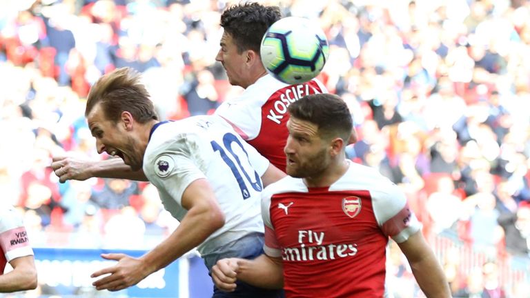 Harry Kane of Tottenham Hotspur is fouled by Shkodran Mustafi of Arsenal resulting in a penalty during the Premier League match between Tottenham Hotspur and Arsenal FC at Wembley Stadium on March 02, 2019 in London, United Kingdom. 