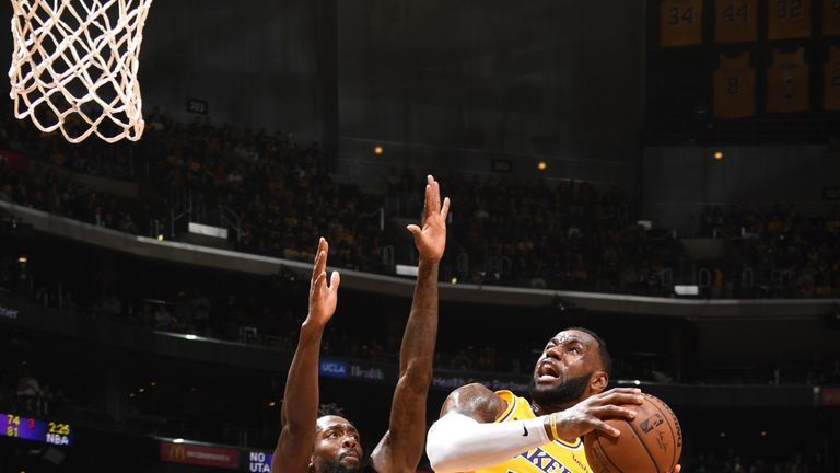 LeBron James absorbs contact in the paint against the Los Angeles Clippers