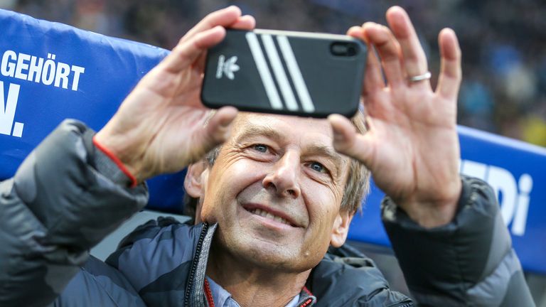 Jürgen Klinsmann hält sein Debüt bei Hertha BSC auf dem Smartphone fest.