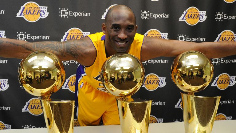 Kobe Bryant pictured with his five NBA titles