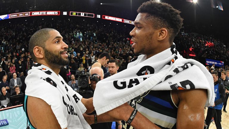 Nicolas Batum and Giannis Antetokounmpo embrace at the conclusion of the NBA Paris Game
