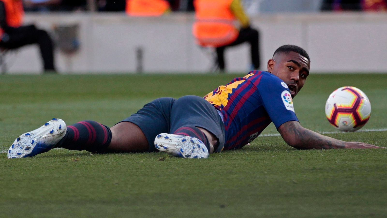  An image of a Barcelona player lying on the ground during a match, with the caption "Barcelonas transfer strategy and player options for Raphinhas replacement".