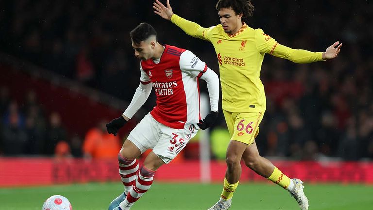 Arsenal's Gabriel Martinelli, left, and Liverpool's Trent Alexander-Arnold battle for the ball during the English Premier League soccer match between Arsenal and Liverpool at Emirates Stadium in London, Wednesday, March 16, 2022. (AP Photo/Ian Walton)