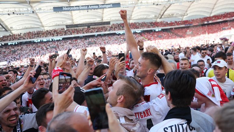 Stuttgarts Torjäger Kalajdzic feiert nach dem Klassenerhalt mit den Fans, nachdem diese den Platz stürmten.