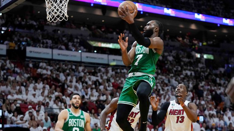 Boston Celtics guard Jaylen Brown (7) drives to the basket over Miami Heat center Bam Adebayo (13) during the second half of Game 4 during the NBA basketball playoffs Eastern Conference finals, Tuesday, May 23, 2023, in Miami. (AP Photo/Wilfredo Lee)