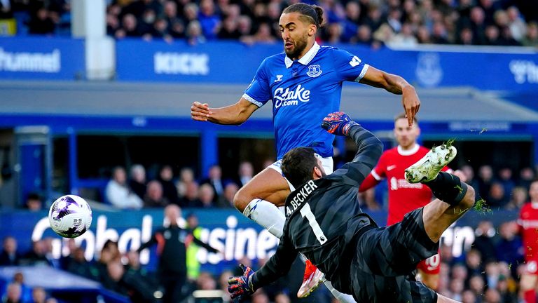 Everton's Dominic Calvert-Lewin, top, is brought down by Liverpool goalkeeper Alisson Becker in the penalty area during a Premier League soccer match at Goodison Park in Liverpool, Wednesday, April 24, 2024. A video review overturned the penalty decision because of offside. (Peter Byrne/PA via AP)