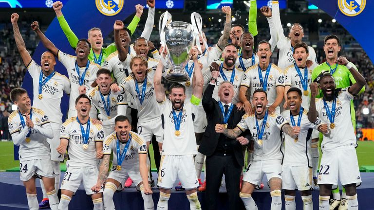 Real Madrid's players celebrate with the trophy after winning the Champions League final soccer match between Borussia Dortmund and Real Madrid at Wembley stadium in London, Saturday, June 1, 2024. (AP Photo/Kirsty Wigglesworth)