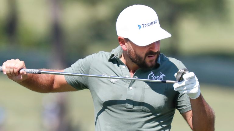 Stephan Jaeger inspects his club on the first hole during the fourth round of the 2024 Sanderson Farms Championship at the Country Club of Jackson on Oct. 06, 2024 in Jackson, Miss. (AP Photo/Sarah Warnock).