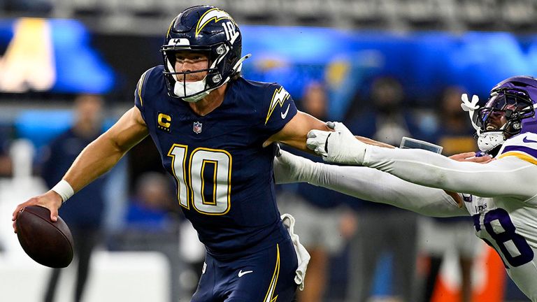 Chargers-Quarterback Justin Herbert (l.) schüttelt seinen Gegner ab.