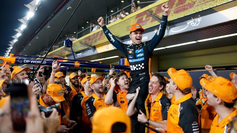Lando Norris feiert nach dem Saisonfinale in Abu Dhabi den Formel-1-Weltmeistertitel 2025 zusammen mit dem McLaren Team.