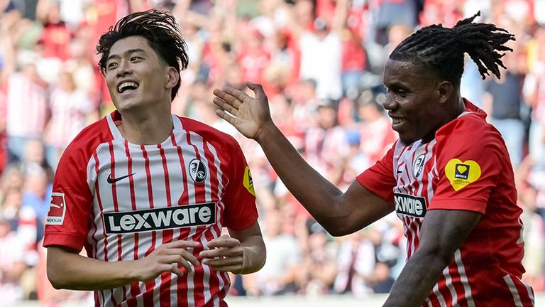 Yuito Suzuki (l.) bejubelt eines seiner drei Tore - Freiburg-Teamkollege Cyriaque Irie freut sich mit.